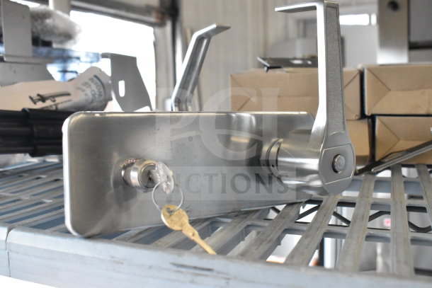 Stainless steel door handles with keys, mounted on a metal plate. New condition, includes two handles.