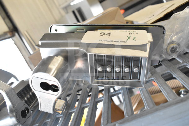 Stainless steel 2 door handles with numeric keypad, new condition, shown with quantity tag "2X" from PCI Auctions.