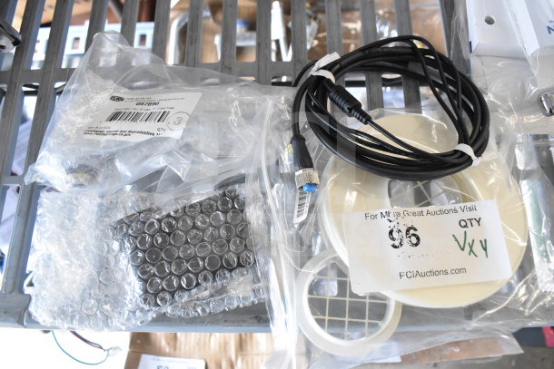 Four items including a Navien exhaust plunge and Delta adapter, in original packaging, with auction label and identifiers.