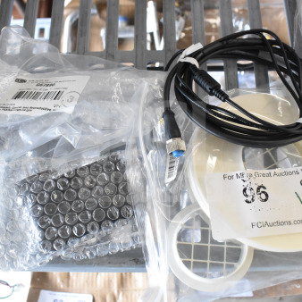 Four items including a Navien exhaust plunge and Delta adapter, in original packaging, with auction label and identifiers.