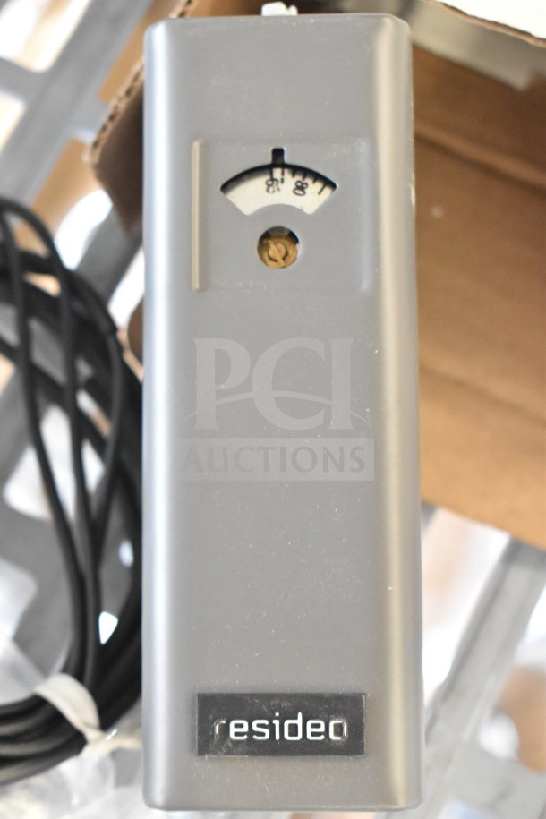 Resideo L6006C Aquastat, gray housing, temperature gauge visible, and power cord attached.
