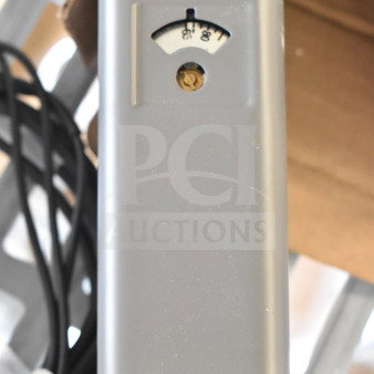 Resideo L6006C Aquastat, gray housing, temperature gauge visible, and power cord attached.