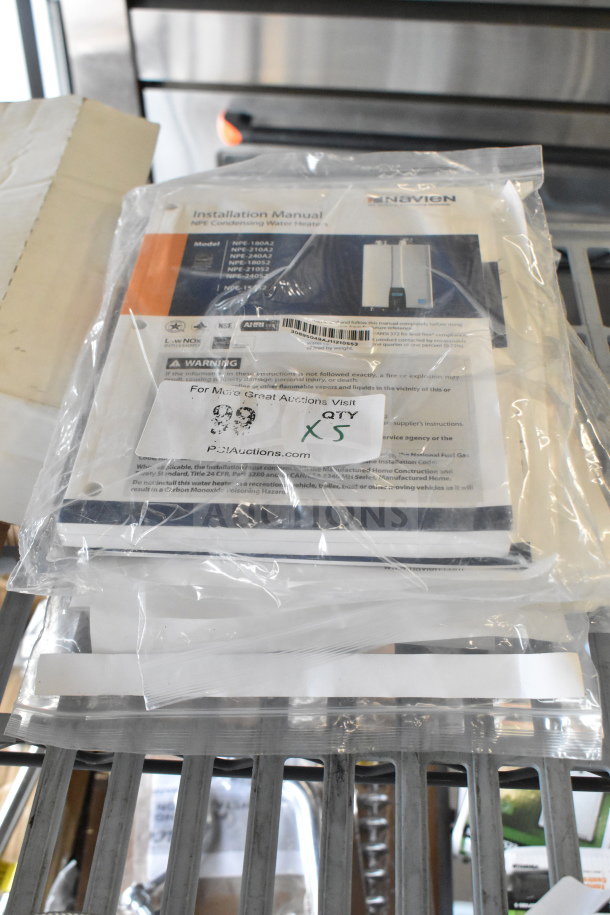Set of 5 Navien NPE Condensing Water Heater Manuals, models NPE-180A to NPE-210S, in sealed packaging, quantity label showing “x5.”