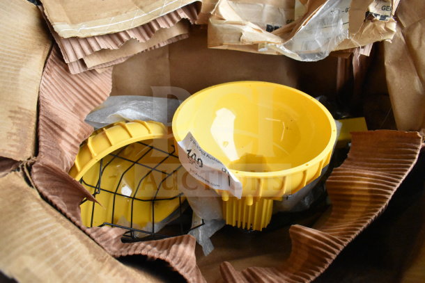 Yellow RP-H-40-P Dock Loading Light in original packaging with protective metal wire guard; labeled for auction.