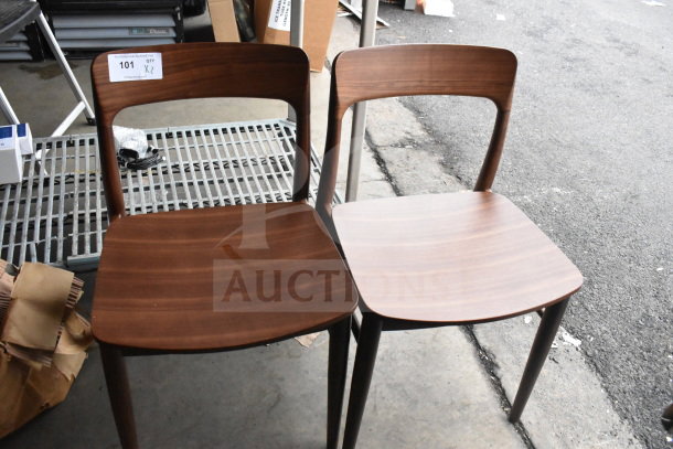 Two wooden dining height chairs with curved backs, dark finish, mild wear. Auction label reads "101 QTY X2".