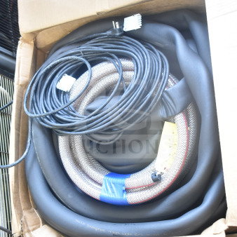 Cardboard box containing an insulation strip, coiled hose, and cable with connectors. Items appear in clean, unused condition.