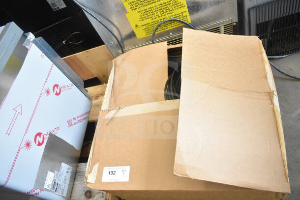Cardboard box containing insulation strip, hose, and cable. Visible label reads "For More Great Auctions Visit PIAuctions.com."