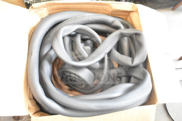 Cardboard box containing insulation strips, hoses, and cables, coiled and in good condition.