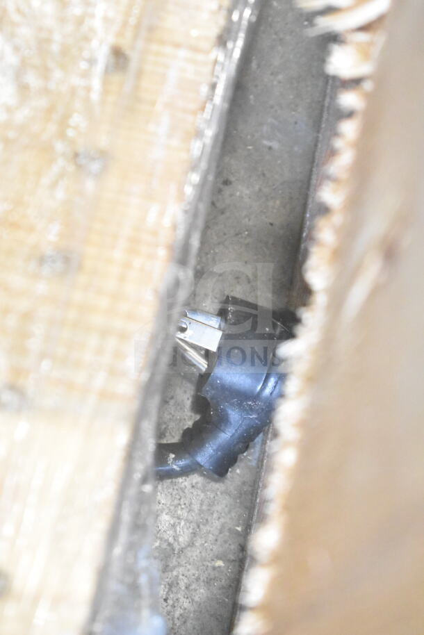 Blurred image showing a close-up of a power plug. Not related to the 2021 True TVM-48SL-HC Commercial Cooler.