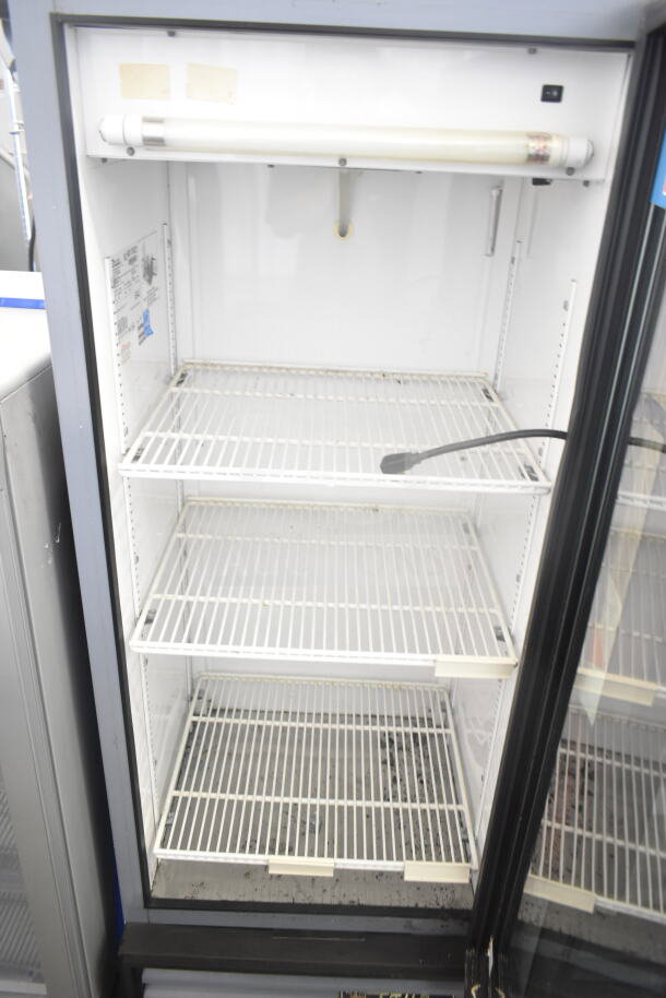True GDM-12 commercial single door cooler merchandiser with shelves. Operates at 115 volts, 1 phase. Good condition.