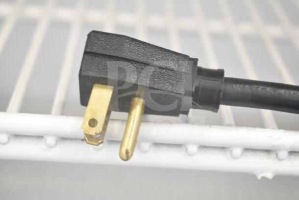 True GDM-12 cooler power plug, showing the 115V connection on a white shelf, no visible damage.