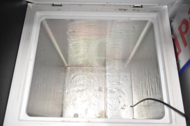 Hisense WFC050M6XWD chest freezer interior, 115 volts, 1 phase, showing spacious storage with some wear.