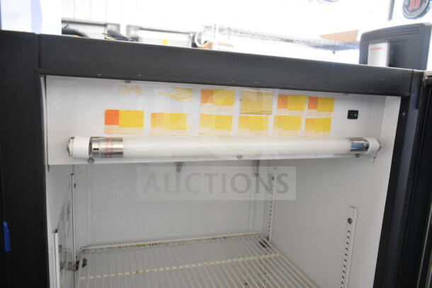 True GDM-12 Commercial Single Door Cooler, interior view. 115 Volts, with shelf, light, and visible labels. Suitable for merchandising.