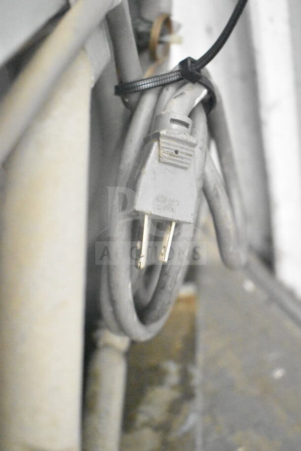 Coiled power cord for a Master-Bilt BGR-14R commercial cooler, 115 volts, shown in storage.
