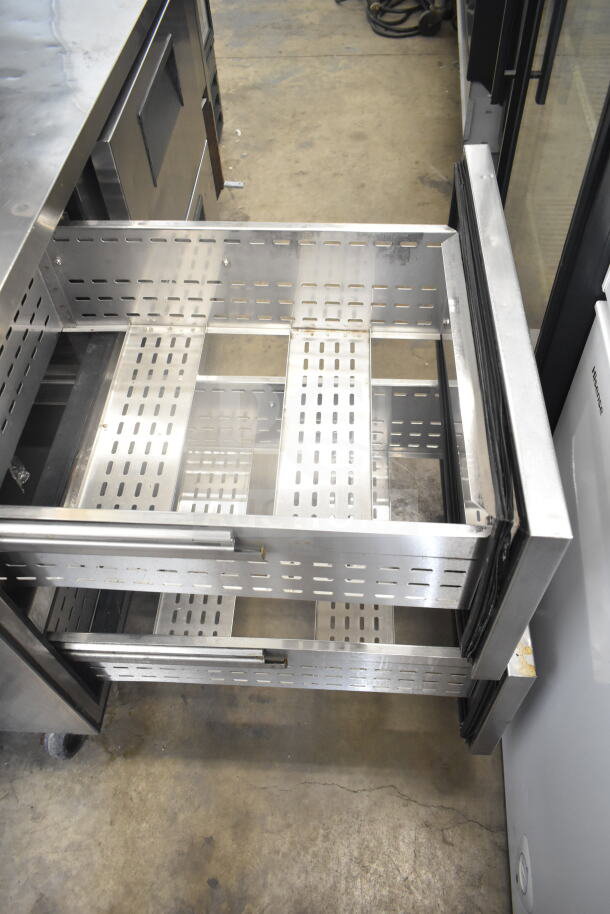 True TPP-67D-4 commercial pizza prep table, features 4 vented drawers, stainless steel construction, on commercial casters.