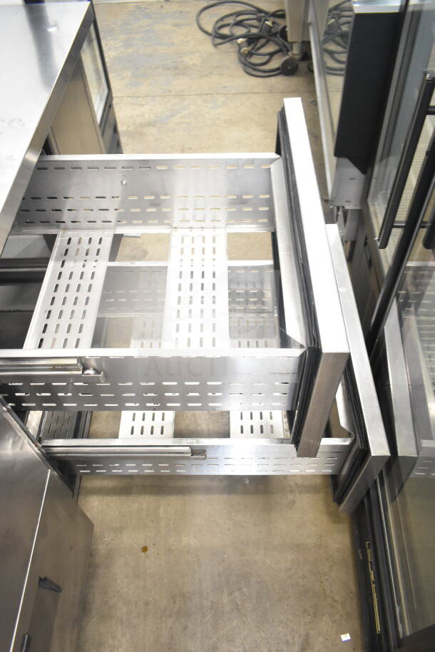 True TPP-67D-4 commercial pizza prep table with 4 stainless steel drawers, 2-tier over shelf, on casters. 115V, 1 phase.