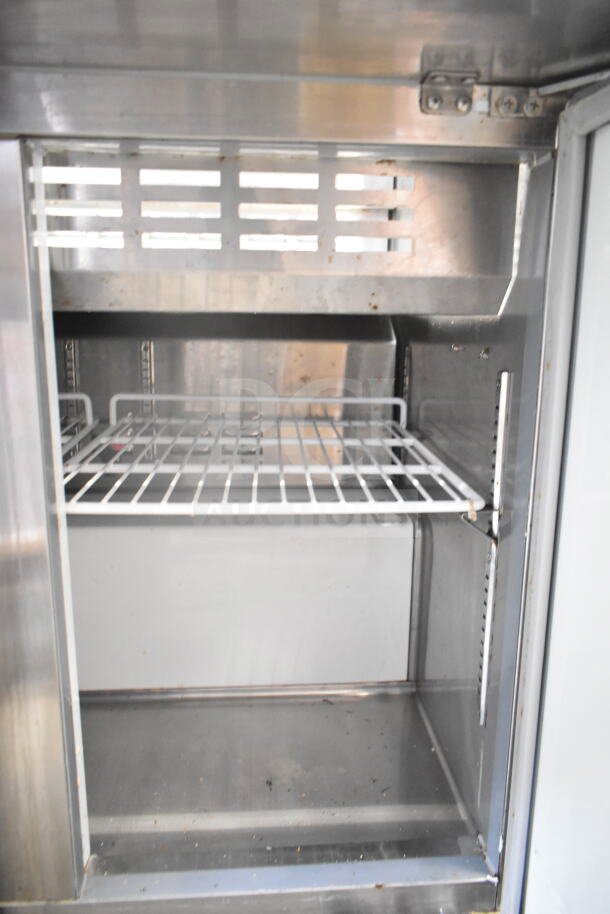 2022 Coldline SMP-36 commercial prep table, missing back lid. Features stainless steel interior with shelf. 115V, 1 phase.