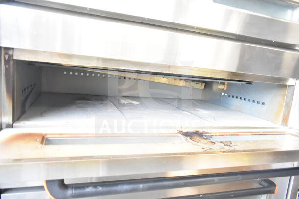 Lusi YCO-4-16D commercial propane gas 4-deck bakery oven. Stainless steel, used condition, interior cooking space visible.