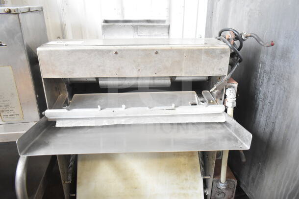 Commercial countertop dough sheeter, 115 volts, 1 phase, stainless steel, pre-owned, includes controls and belt.