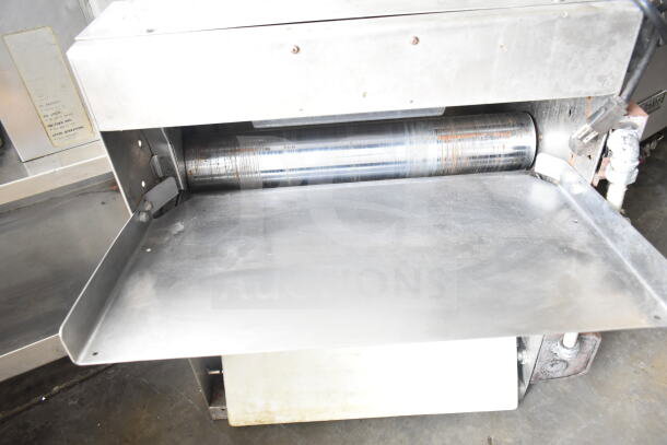 Commercial countertop dough sheeter, stainless steel, 115 volts, 1 phase, visible wear, ideal for bakery use.