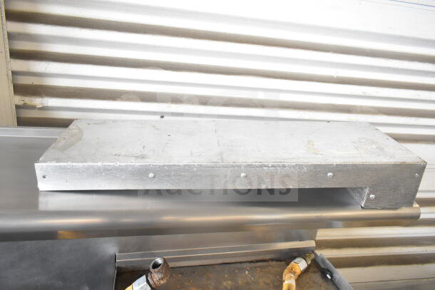 American Range commercial gas-powered 6-burner range with flat top griddle, dual ovens, backsplash, and overshelf.