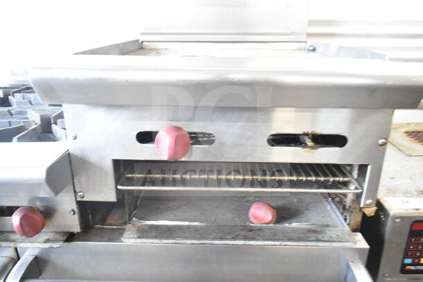 American Range commercial gas-powered 6-burner range with flat top griddle, two ovens, backsplash, and overshelf.