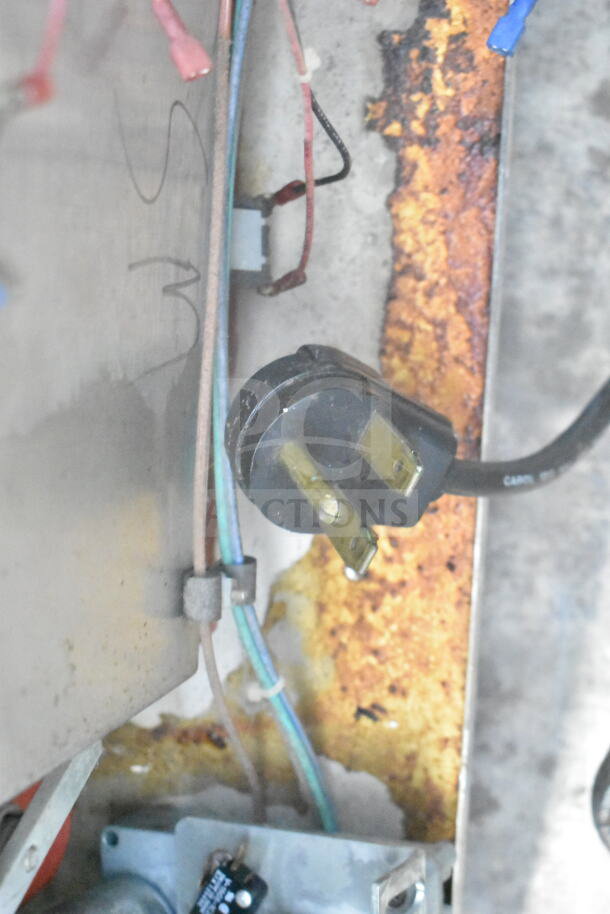 Corroded and worn interior view of Autofry MTI-10 Fryer with visible electrical plug and wiring.