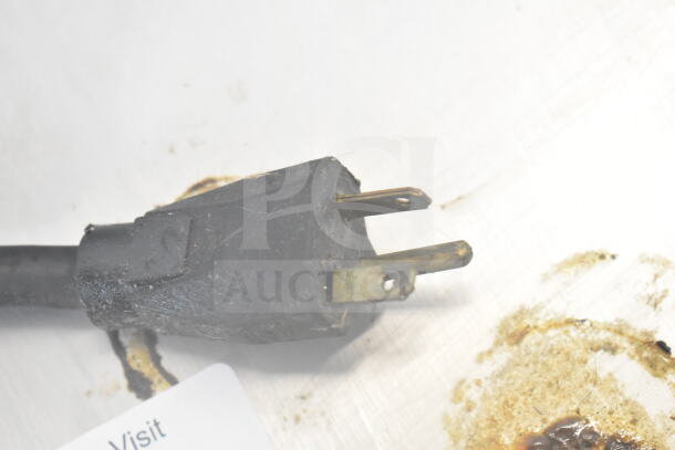 Close-up of a power plug for an Autofry FFG-10 Commercial Ventless Fryer, 208/240V, 1 Phase. Plug appears used.