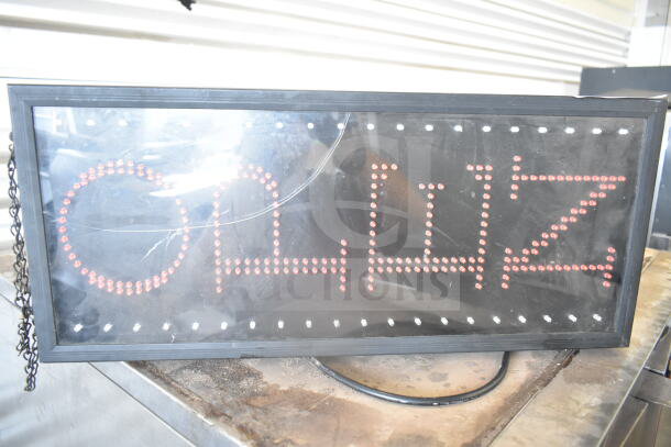 Illuminated "Open" sign with red LED lights and a black frame, showing wear. Includes hanging chain and power cord.