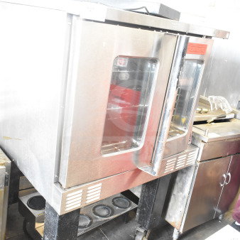 Garland commercial gas convection oven with view-through doors, thermostatic controls, metal legs, and casters.