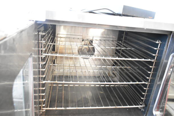 Garland commercial gas convection oven, full size, view-through doors, thermostatic controls, metal legs, commercial casters.