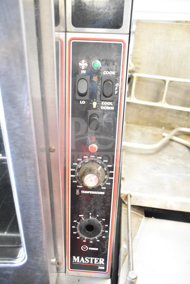 Garland commercial gas convection oven with view-through doors, thermostatic controls, metal legs, and casters.