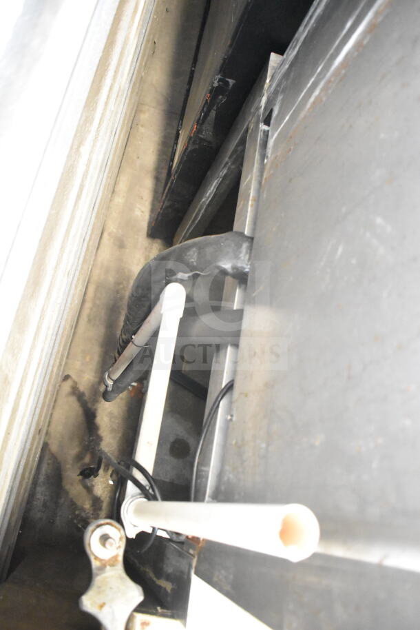 Scotsman commercial ice dispenser, 115 volts, 1 phase; industrial piping visible; condition requires verification.