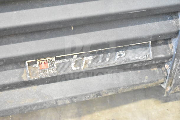 True GDM-37 commercial cooler badge, showing model and brand markings. Slight wear visible on the label.
