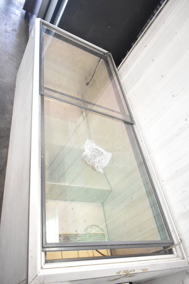 Chest Freezer Merchandiser with glass top, 115 volts, 1 phase, used condition, visible power cord, some exterior wear.