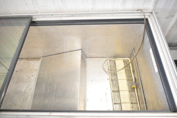 Chest freezer merchandiser, interior view, 115 volts, single phase. Visible wear, clean interior, sliding glass top.