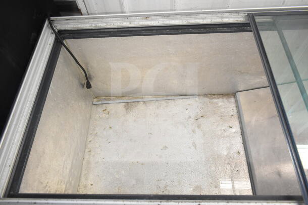 Chest Freezer Merchandiser, 115 Volts, 1 Phase. Features glass top, interior stains, and visible power cord. Moderate condition.