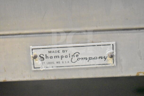 Shampaine Commercial Merchandising Cabinet with "Made by Shampaine Company, St. Louis, MO, USA" label, showing some age wear.
