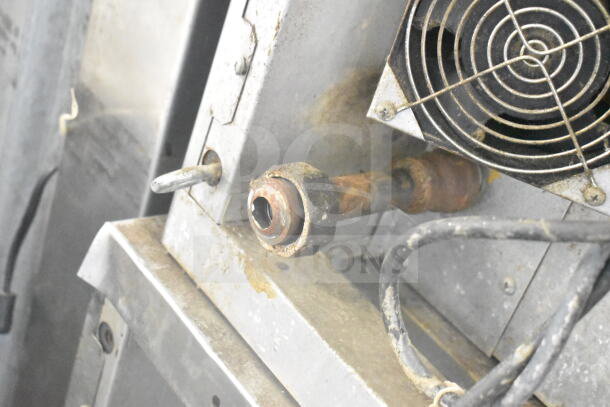 Blodgett commercial gas convection oven with rusted pipe, fan, and visible wiring, highlighting details and wear.