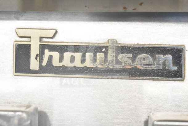 Traulsen logo on stainless steel surface of Traulsen RDT 2-24 DUT Commercial Reach In refrigerator, featuring 2 doors and 2 drawers.