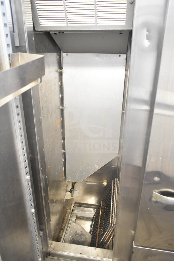 Traulsen RDT 2-24 DUT commercial reach-in fridge interior, stainless steel, two doors, two drawers, visible shelving.