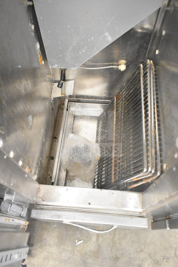 Traulsen RDT 2-24 DUT commercial reach-in interior, showing metal shelves, slight wear, 115 volts, 1 phase.