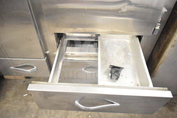 Traulsen RDT 2-24 DUT commercial reach-in with two doors, two drawers, 115V, 1 phase, showing open metal drawer detail.