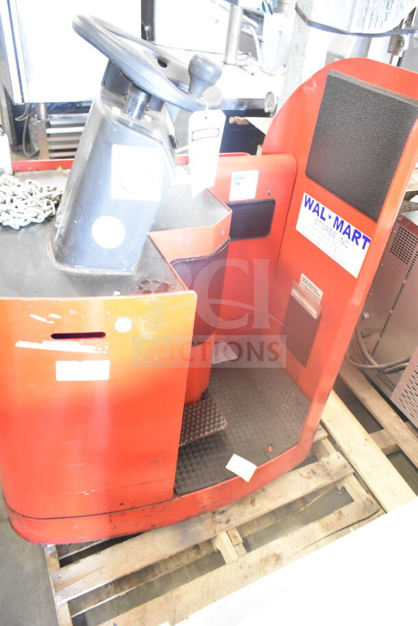 Raymond Deka 19-F60L forklift, red, includes battery, no forks, visible Walmart label, moderate wear, on wooden pallet.
