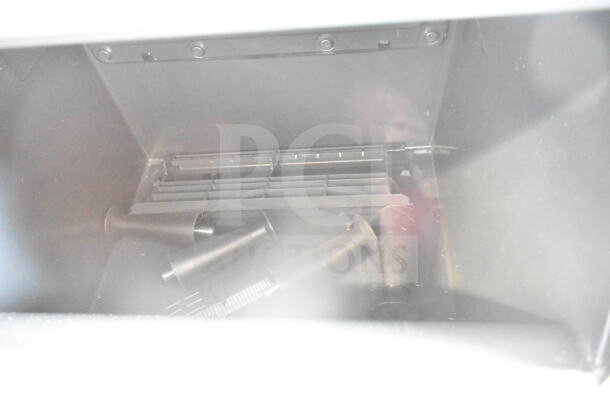 Brand new Scotsman UC2024MAX-1A ice machine interior view, showing medium cube ice area and components, minor dent.