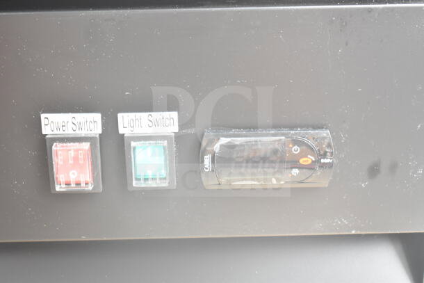 Control panel of Avantco 178GDC40HCB Merchandiser Refrigerator with labeled switches for power and light, and a digital display.