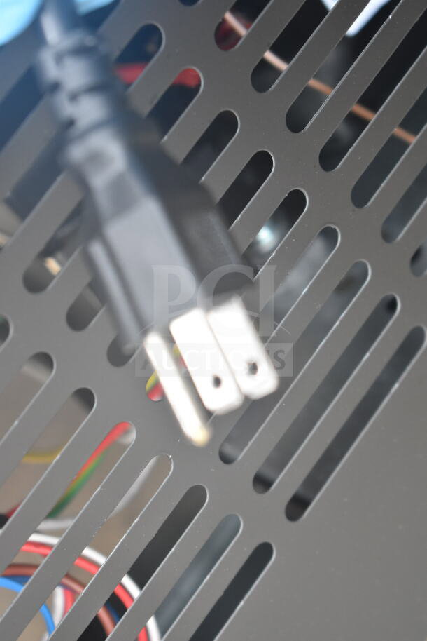 Close-up of a power plug for the Avantco 178GDC40HCB commercial refrigerator; metal grid panel in the background.