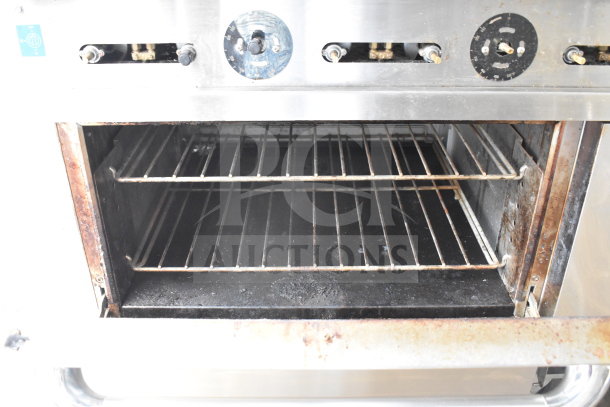 PrecisionHD commercial gas range oven interior, showing racks. Features six burners, griddle, dual ovens, and shelving.