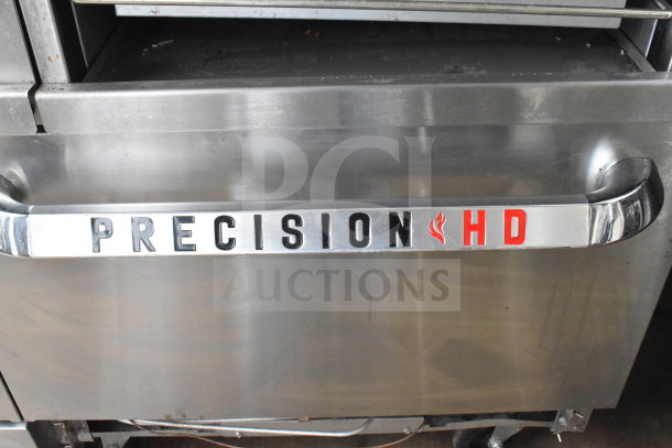 PrecisionHD commercial 6-burner gas range with flat top griddle, 2 ovens, overshelf, backsplash, and casters. Logo visible.
