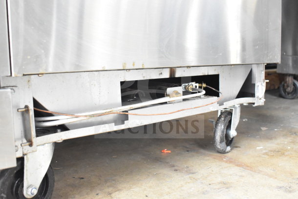 PrecisionHD commercial gas range underside with casters visible, showcasing sturdy construction.